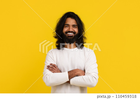Stylish young indian guy posing isolated on yellow background 110459318