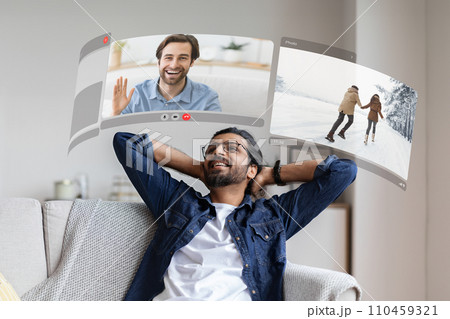 VR glasses transport young man into an digital world, redefining the way he connects with friends via digital screen VR glasses transport young man into an digital world, redefining the way he connects with friends via digital screen 110459321