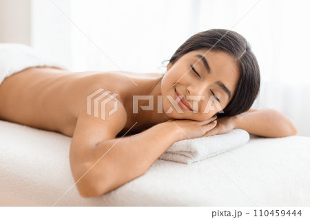 Relaxed young indian woman resting after healing back massage 110459444