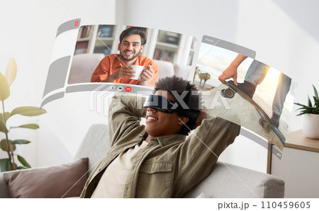 Young african american guy dives into virtual reality for immersive video conversations with friends from home 110459605