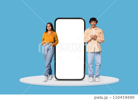 Happy young couple with smartphones by giant phone mockup Happy young couple with smartphones by giant phone mockup 110459890
