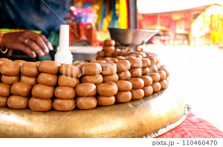 Indian Sweet shop display peda or pera outside of temple 110460470