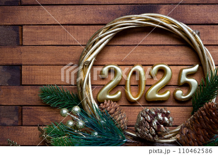 Happy New Year golden numbers 2025 on cozy festive brown wooden background with sequins, snow, lights of garlands. Greetings, postcard. Calendar, cover Happy New Year golden numbers 2025 on cozy festive brown wooden background with sequins, snow, lights of garlands. Greetings, postcard. Calendar, cover 110462586