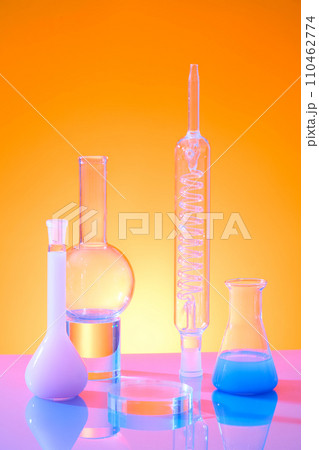 A glass round podium for product display decorated with lab equipments on color gradient background. Front view, science laboratory research and development concept 110462774
