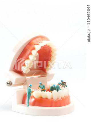 Miniature people , Dentist repairing human teeth with gums and enamel 110462843