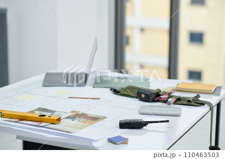 Workplace of construction worker with laptop, blueprints and tools Workplace of construction worker with laptop, blueprints and tools 110463503