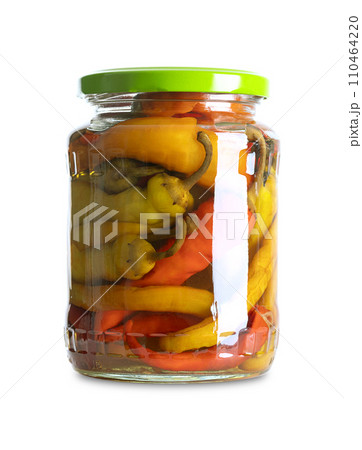 Pepperonis, pickled cayenne peppers in a glass jar. Green, red, and yellow fruits of moderately hot chili peppers, pasteurized and preserved in a brine of vinegar and salt. Close-up, front view. Photo Pepperonis, pickled cayenne peppers in a glass jar. Green, red, and yellow fruits of moderately hot chili peppers, pasteurized and preserved in a brine of vinegar and salt. Close-up, front view. Photo 110464220