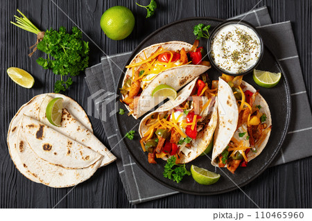 baked tex-mex chicken fajitas on a plate, top view baked tex-mex chicken fajitas on a plate, top view 110465960
