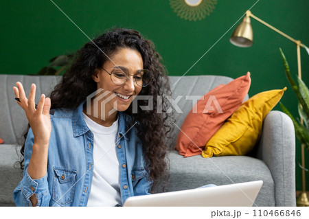 Close-up of joyful woman studying at home, watching video tutorial course, smiling contentedly sitting on sofa in living room, talking with teacher mentor using video call on laptop. Close-up of joyful woman studying at home, watching video tutorial course, smiling contentedly sitting on sofa in living room, talking with teacher mentor using video call on laptop. 110466846