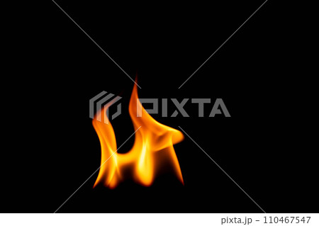 Hot flames on a black background. Beautiful flame of fire in the dark. Abstract of burning flames and smoke. Hot flames on a black background. Beautiful flame of fire in the dark. Abstract of burning flames and smoke. 110467547