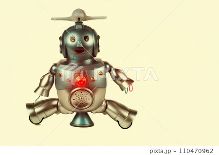 Vintage toy robot on a beige background. Robotics. Vintage toy robot on a beige background. Robotics. 110470962
