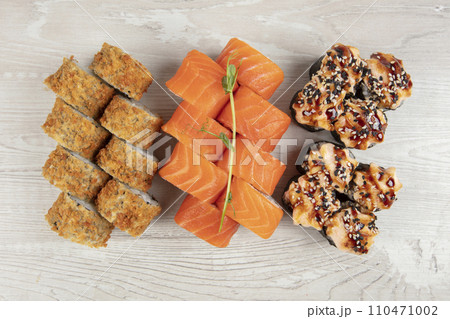 Set of various sushi rolls on a white wooden background close-up. 110471002