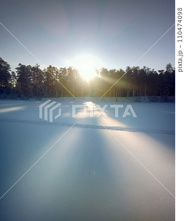 Spruce tree forest covered with snow and frozen lake. Spruce tree forest covered with snow and frozen lake. 110474098