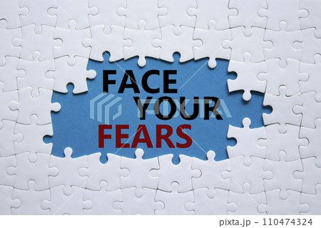 Face your Fears symbol. Concept words Face your Fears on white puzzle. Beautiful blue background. Business and Face your Fears. Copy space. 110474324