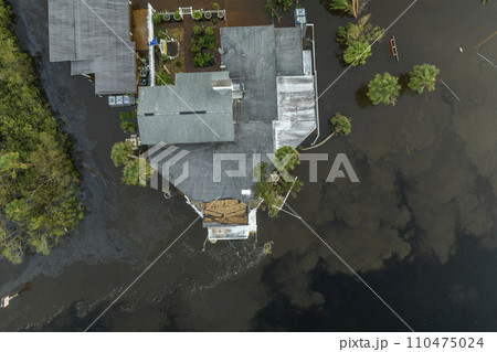 Aftermath of natural disaster. Surrounded by hurricane Ian rainfall flood waters homes in Florida residential area Aftermath of natural disaster. Surrounded by hurricane Ian rainfall flood waters homes in Florida residential area 110475024