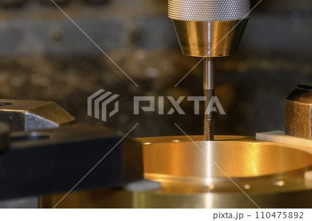 The tapping process on NC milling machine with brass material. 110475892