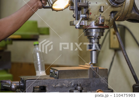 The NC milling machine face milling the metal parts. The NC milling machine face milling the metal parts. 110475903