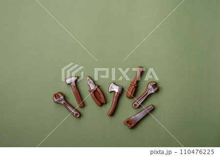 Tools and inscriptions symbolizing repairs or a garage and its attributes on a plain background 110476225