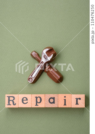 Tools and inscriptions symbolizing repairs or a garage and its attributes on a plain background 110476250