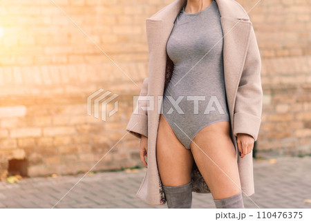 Fashion portrait of sexy woman in mask and lingerie in autumn park. Pandemic, virus, coronavirus Fashion portrait of sexy woman in mask and lingerie in autumn park. Pandemic, virus, coronavirus 110476375