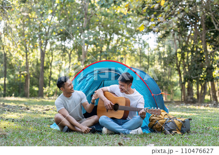 Happy Asian male gay couple on camping together in a forest. romantic vocation trip. lgbt concept 110476627