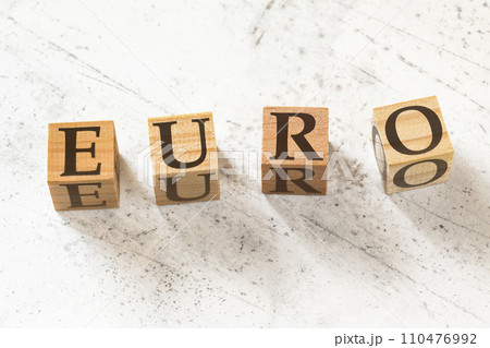 Four wooden cubes with word EURO on white working board Four wooden cubes with word EURO on white working board 110476992