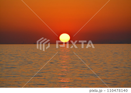 地平線に沈む夕日 快晴の空 穏やかな海 地平線に沈む夕日 快晴の空 穏やかな海 110478140