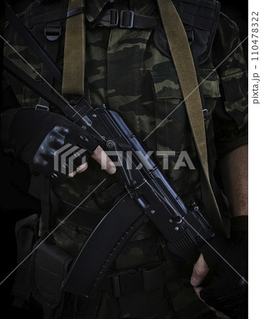 fighter in camouflage with a Kalashnikov assault rifle in his hands fighter in camouflage with a Kalashnikov assault rifle in his hands 110478322