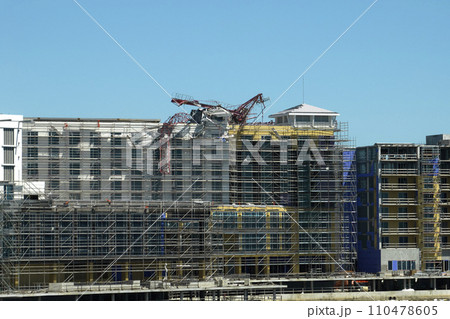 Aerial view of ruined by hurricane Ian construction crane on high apartment building site in Port Charlotte, USA 110478605