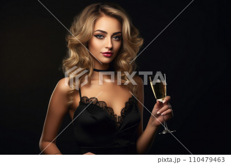Woman holds glass of wine on dark background 110479463