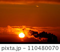 Dramatic black smoke with orange dawn sky with the rising sun. 110480070