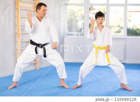 Man and boy teenager train karate technique Man and boy teenager train karate technique 110480126