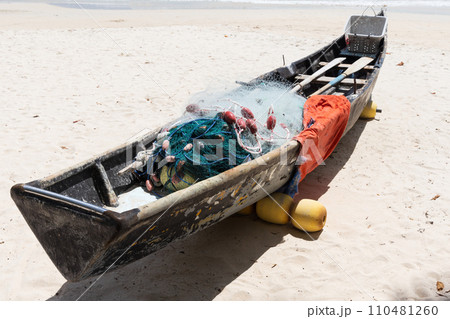 Old boat with fishing nets lays on white sand of Beau Vallon Beach, Seychelles Old boat with fishing nets lays on white sand of Beau Vallon Beach, Seychelles 110481260