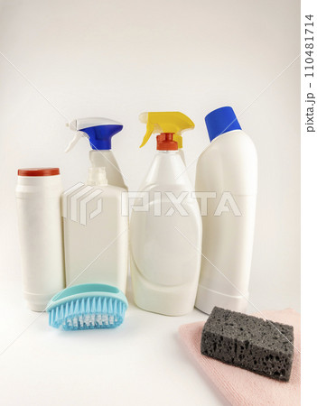 Various detergents. A set of different white plastic bottles and a cleaning brush. The concept of cleaning the house. Various detergents. A set of different white plastic bottles and a cleaning brush. The concept of cleaning the house. 110481714