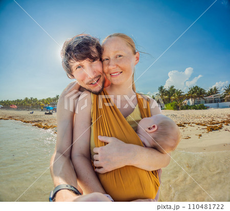 New parents cherish a beach day with their newborn a heartwarming family moment by the shore New parents cherish a beach day with their newborn a heartwarming family moment by the shore 110481722