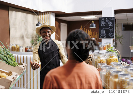 An eco friendly grocery store owned by a welcoming black man, who offers a variety of sustainable products in reusable packaging. Customers are greeted with open arms and friendly service. 110481878