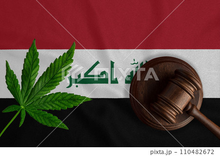 Justice wooden gavel with cannabis leaf on the Flag of Iraq. Illegal growth of cannabis plant and drugs spreading Justice wooden gavel with cannabis leaf on the Flag of Iraq. Illegal growth of cannabis plant and drugs spreading 110482672