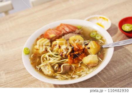 A steaming bowl of Soto Mie Bogor, a traditional Indonesian noodle soup A steaming bowl of Soto Mie Bogor, a traditional Indonesian noodle soup 110482930