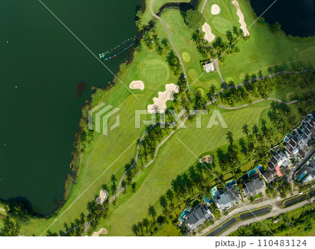 Aerial view of beautiful green golf field fairway and putting green,Top view image for sport background and travel nature background, Amazing green nature view Aerial view of beautiful green golf field fairway and putting green,Top view image for sport background and travel nature background, Amazing green nature view 110483124