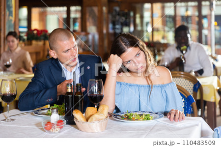 Unhappy couple quarreling during dinner at restaurant 110483509