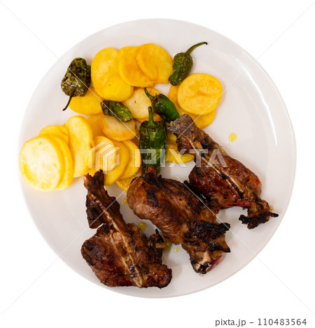 Spanish dish of pork cheeks with potatoes on round plate Spanish dish of pork cheeks with potatoes on round plate 110483564