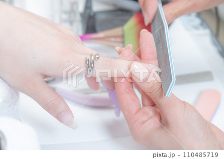 ネイルサロン_ファイルを使ってネイルの形を整えている2 110485719
