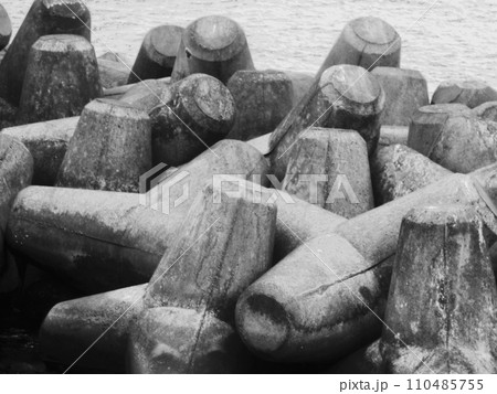 black stones on the sea shore 110485755