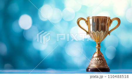 Golden Trophy Award on Soft Blue Bokeh Background,Success and Achievement Concept 110488518