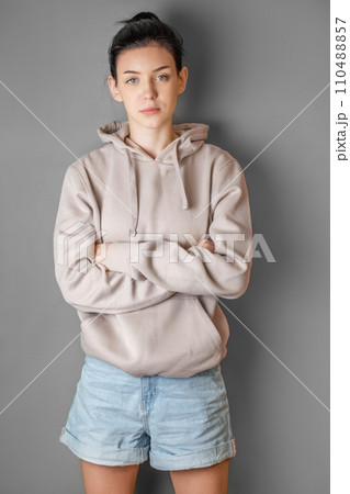 Pensive thoughtful young girl wearing sweatshirt with hood 110488857