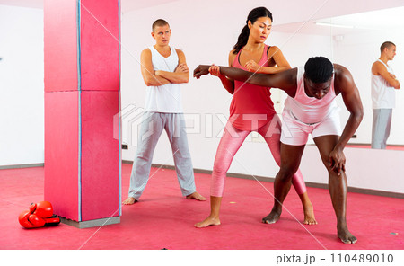 Man and woman exercising during self-defence trainin 110489010