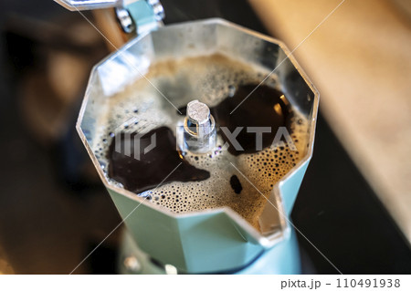 Geyser coffee maker with coffee drink on home kitchen stove in the morning Geyser coffee maker with coffee drink on home kitchen stove in the morning 110491938