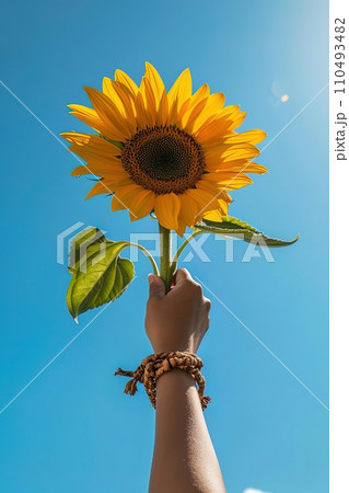 Uplifted sunflower against blue sky symbolizing optimism and nature. AI Generated. 110493482