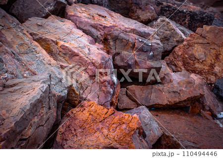 Big seaside rock texture concept photo. Panoramic Mediterranean close up red stones. 110494446