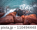 Mediterranean winter stormy seaside. Close up water with stones on the beach concept photo. 110494448